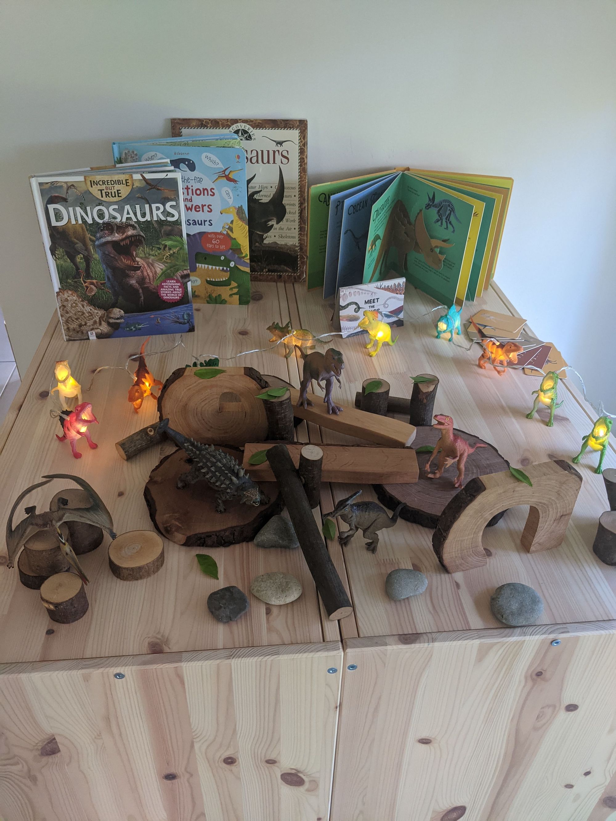 Small-world literacy play setup with figures and letters